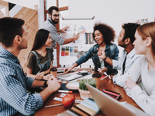 Diverse team of people planning strategy around table